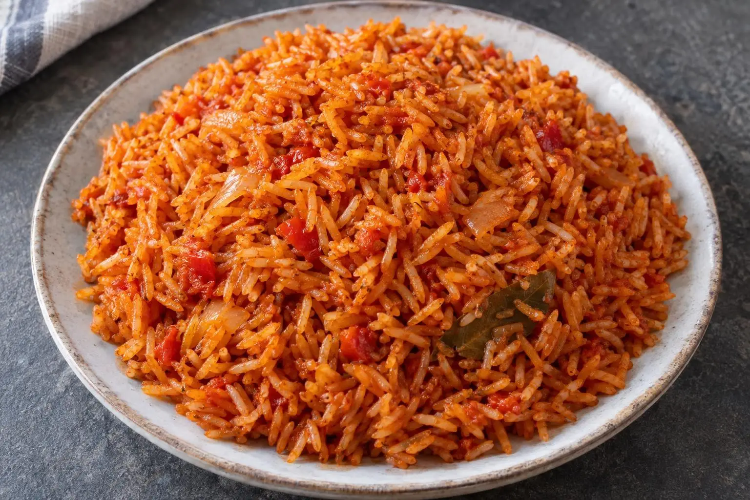 Jollof rice with a slow-fried tomato base plated and ready to serve