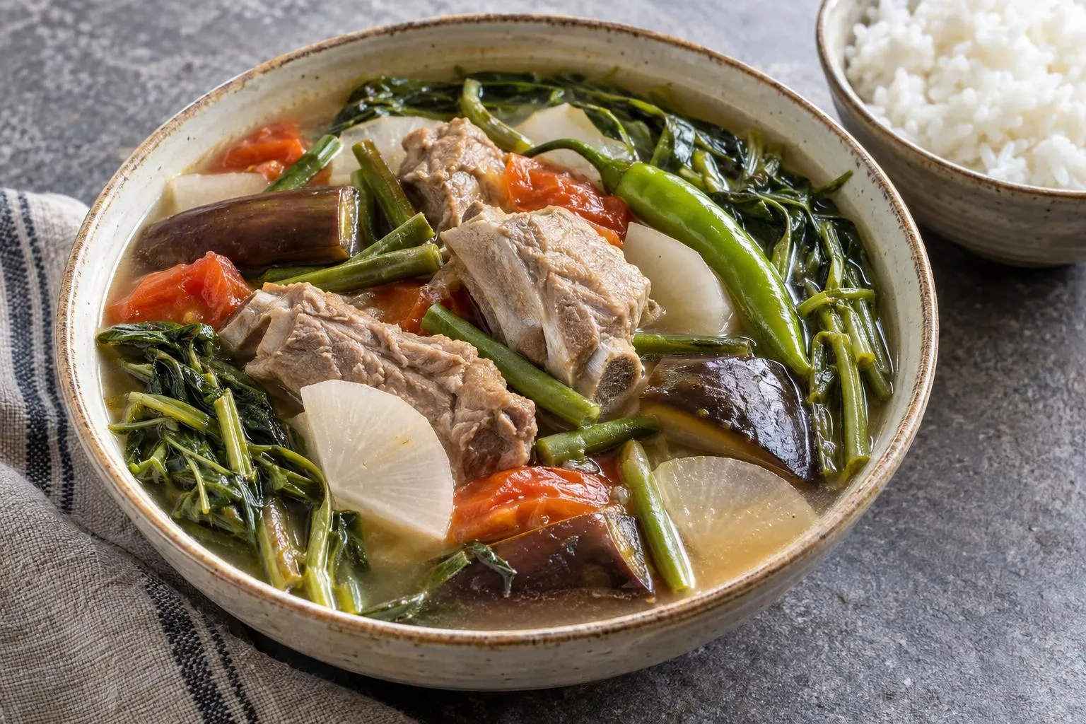 Sinigang na baboy with tamarind broth plated and ready to serve